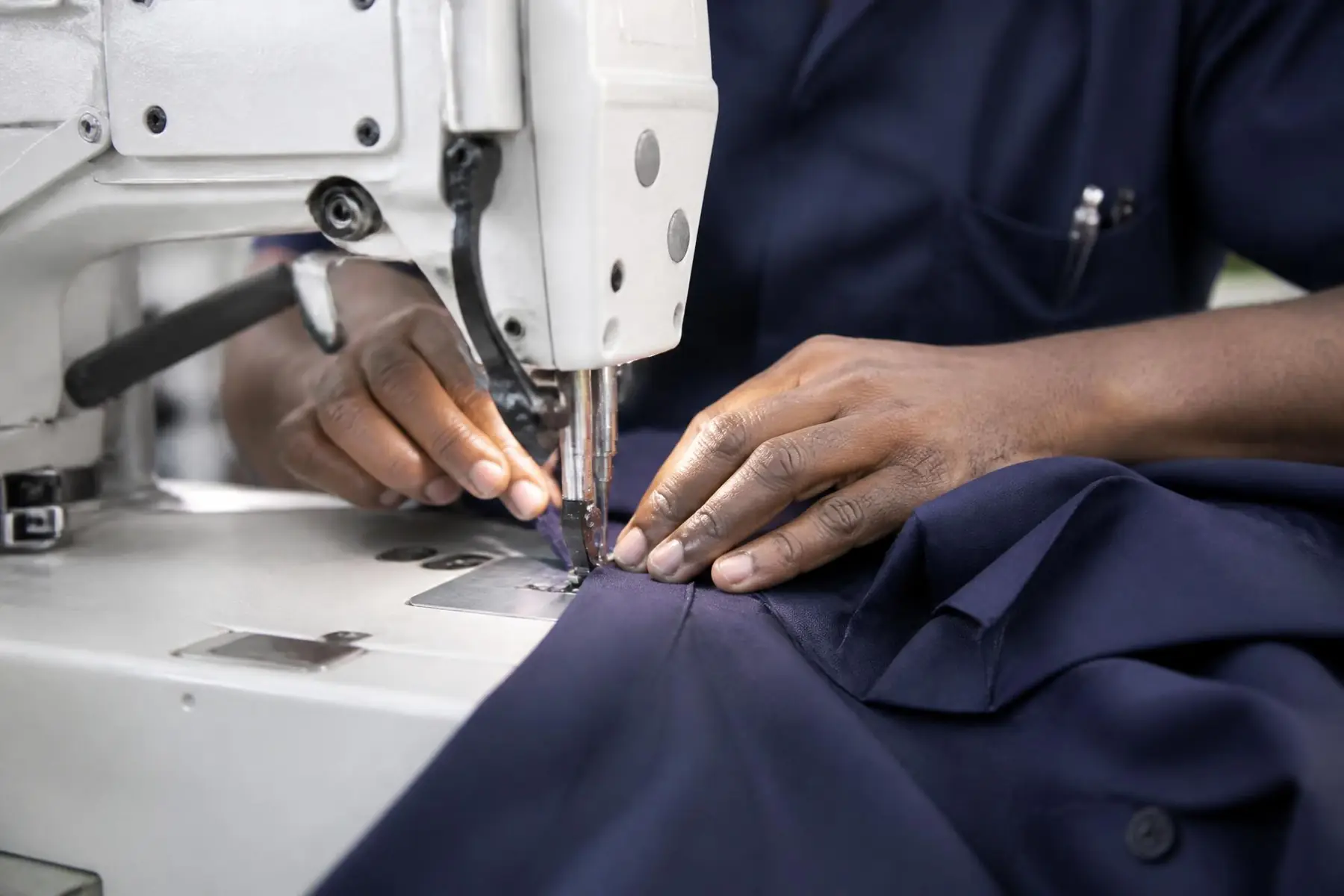 Close-up of industrial sewing and garment construction at Oyertur
